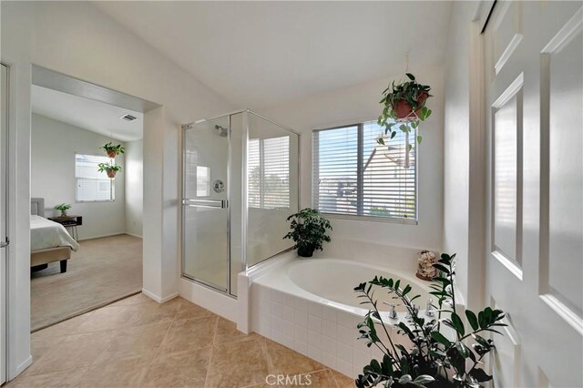 bathroom featuring tile patterned flooring, lofted ceiling, and plus walk in shower