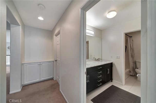 bathroom featuring tile patterned floors, vanity, toilet, and curtained shower