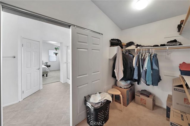 walk in closet with lofted ceiling