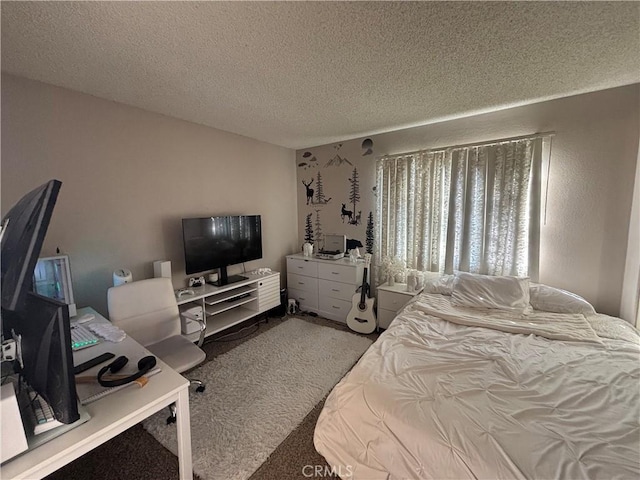 carpeted bedroom featuring a textured ceiling