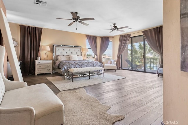 bedroom featuring access to exterior, ceiling fan, and hardwood / wood-style flooring