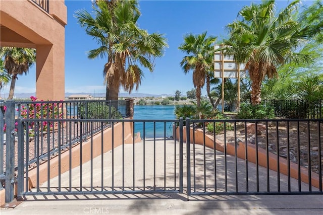 view of gate with a water view