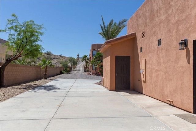 view of property exterior with a patio