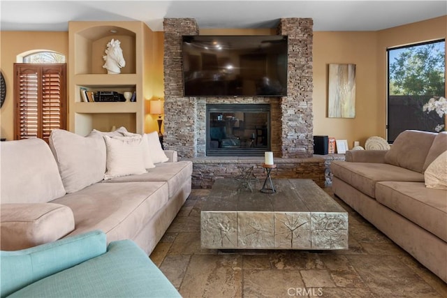 living room with built in features and a fireplace