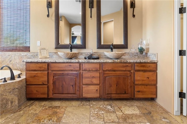 bathroom with vanity and a tub to relax in