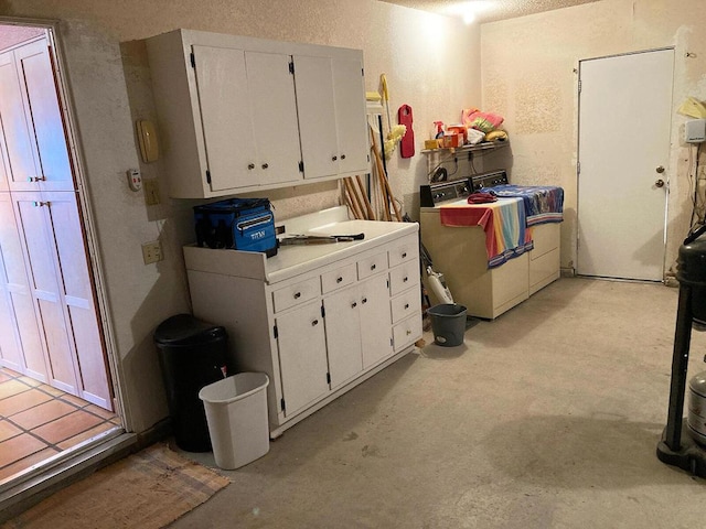 interior space with a textured ceiling and washer / clothes dryer