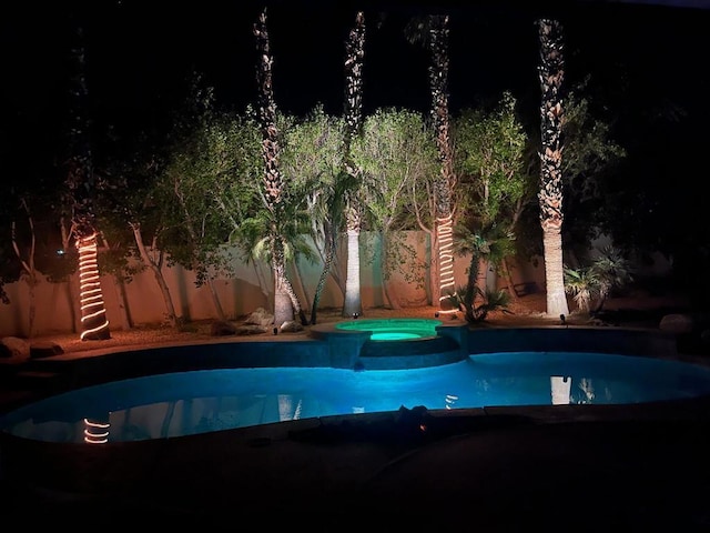 view of swimming pool with an in ground hot tub