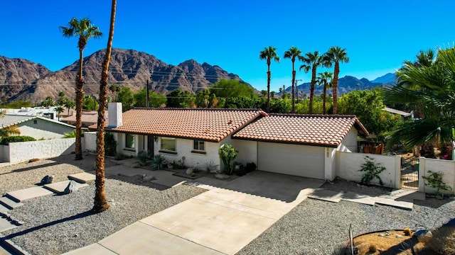 view of front facade featuring a mountain view and a garage