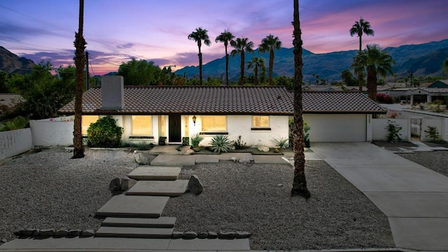 view of front of home featuring a mountain view and a garage