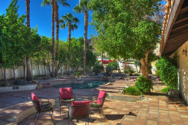 view of patio with a fenced in pool