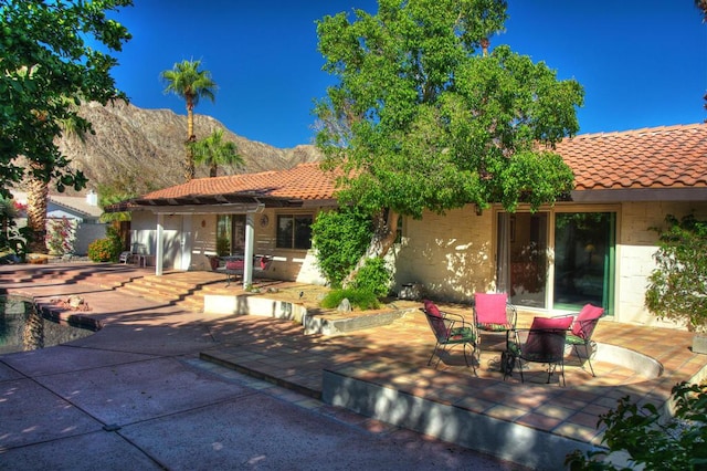 rear view of property with a mountain view