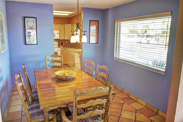 dining area featuring light tile patterned flooring