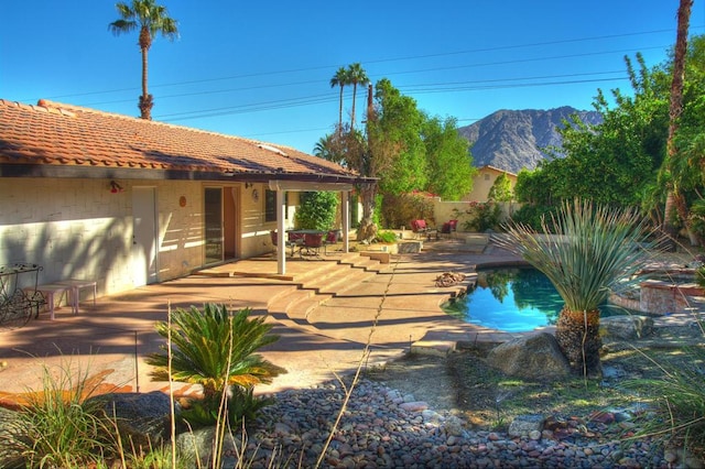 view of swimming pool featuring a mountain view and a patio area