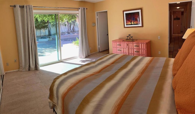 bedroom featuring access to exterior and light colored carpet