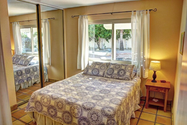 tiled bedroom with a closet