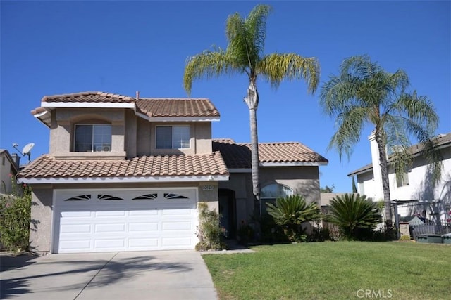 mediterranean / spanish-style home featuring a front yard and a garage