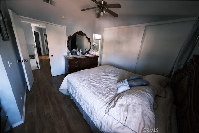 bedroom with vaulted ceiling, ceiling fan, and dark wood-type flooring