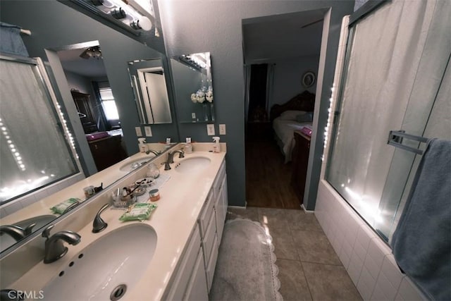 bathroom with tile patterned floors, vanity, and walk in shower