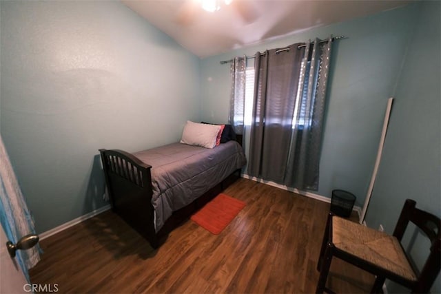 bedroom with dark hardwood / wood-style floors, ceiling fan, and vaulted ceiling