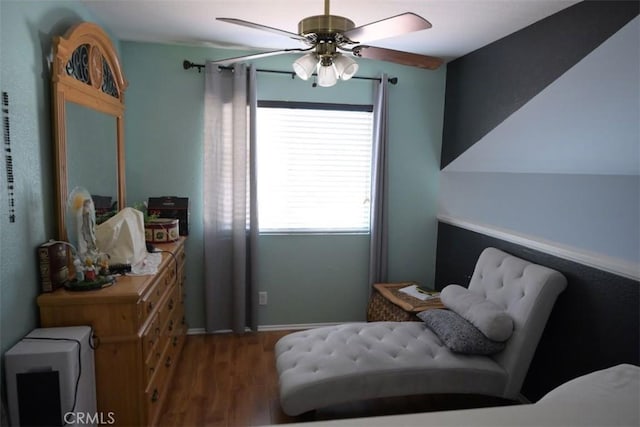 living area featuring wood-type flooring and ceiling fan