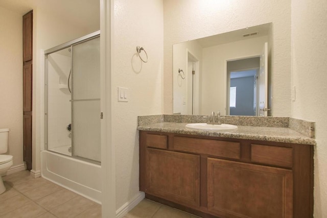 full bathroom with toilet, vanity, tile patterned flooring, and shower / bath combination with glass door