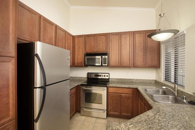 kitchen featuring decorative light fixtures, sink, appliances with stainless steel finishes, and crown molding