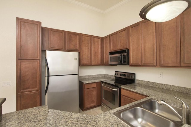 kitchen featuring light stone countertops, appliances with stainless steel finishes, sink, and ornamental molding