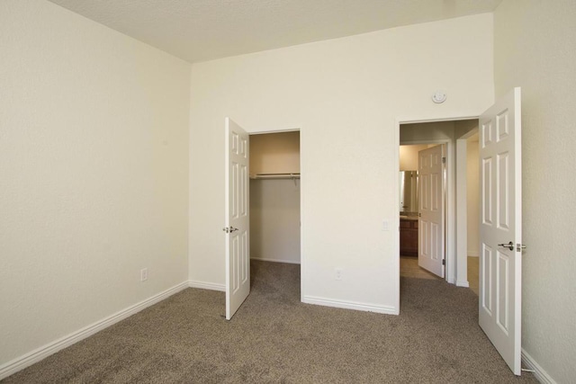 unfurnished bedroom featuring carpet floors and a closet