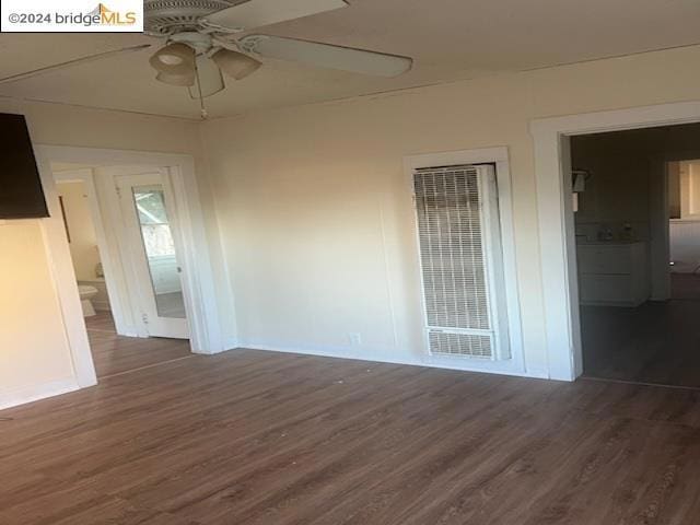 empty room featuring dark hardwood / wood-style floors and ceiling fan