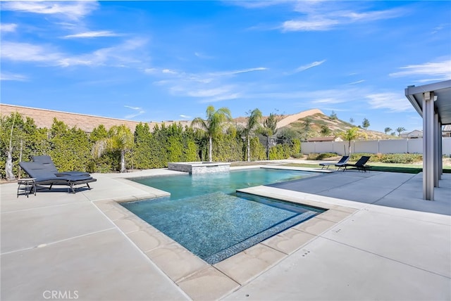 view of swimming pool featuring an in ground hot tub and a patio