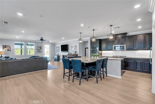 dining area with ceiling fan, light hardwood / wood-style flooring, and ornamental molding