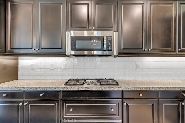 kitchen featuring dark brown cabinets and stainless steel appliances