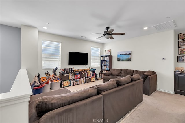 living room with ceiling fan and light colored carpet