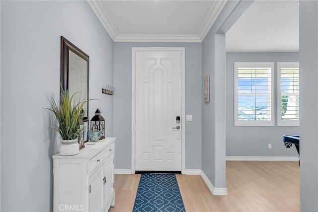 foyer entrance with crown molding and light wood-type flooring