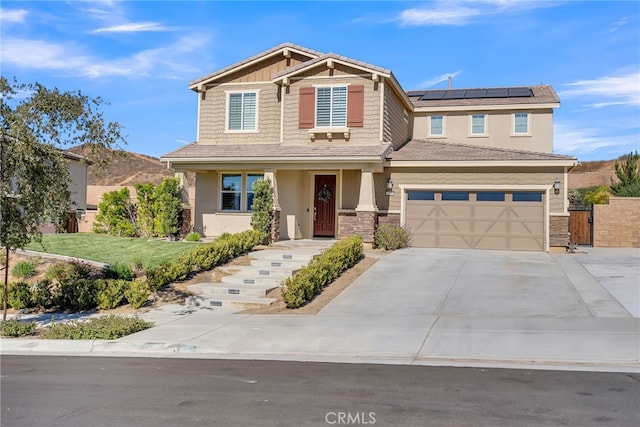 craftsman-style house with a mountain view, solar panels, a garage, and a front lawn