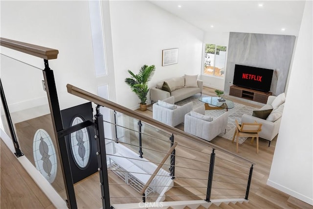 living room featuring a large fireplace and light hardwood / wood-style floors