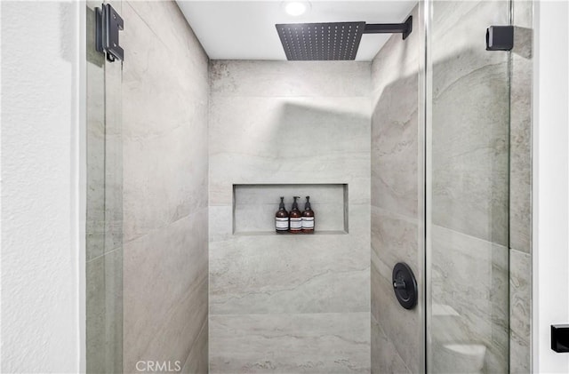 bathroom with a tile shower