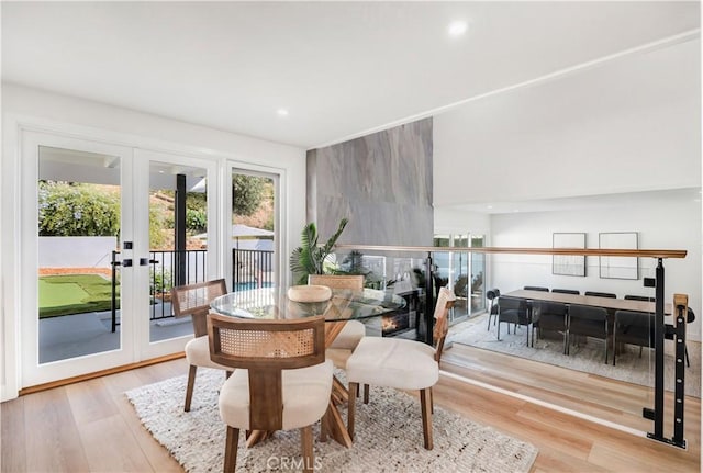 dining room featuring french doors and light hardwood / wood-style floors