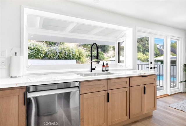 kitchen with dishwasher, french doors, lofted ceiling with beams, sink, and light wood-type flooring