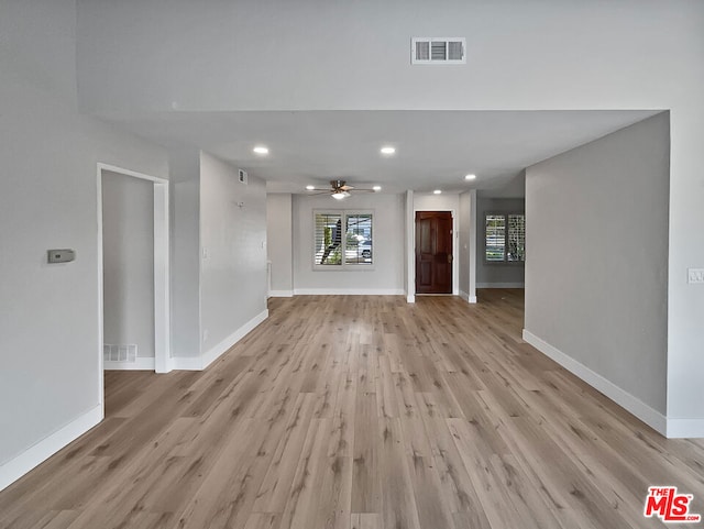 unfurnished living room featuring ceiling fan and light hardwood / wood-style flooring