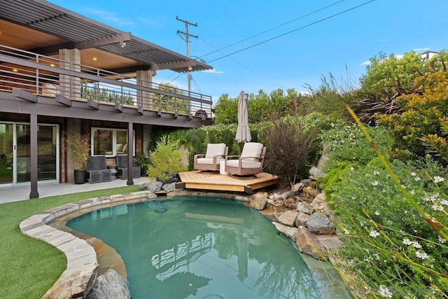 view of swimming pool featuring a pergola, a patio, and a deck