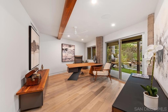 office with beam ceiling, light wood-type flooring, and ceiling fan