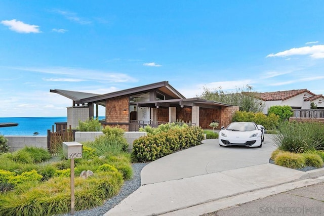 view of front of home with a water view