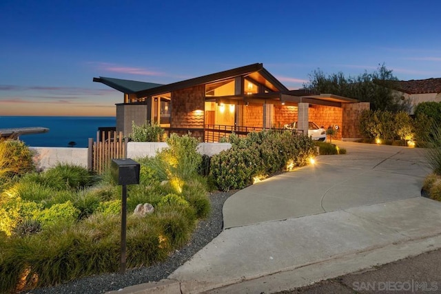 view of front of home with a water view