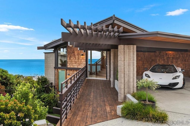 exterior space featuring a water view and a carport