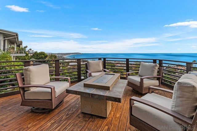 balcony featuring a water view and an outdoor hangout area