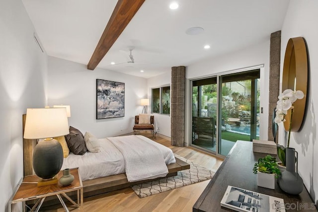 bedroom with beam ceiling, access to exterior, and hardwood / wood-style flooring