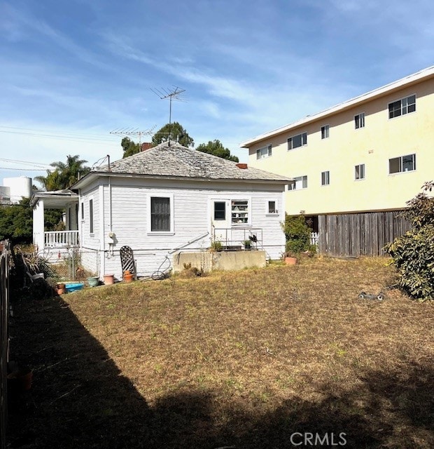 rear view of property featuring a yard