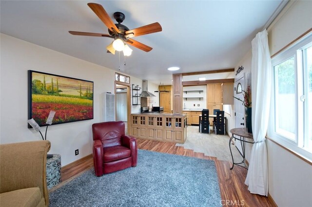 sitting room with ceiling fan and light hardwood / wood-style floors