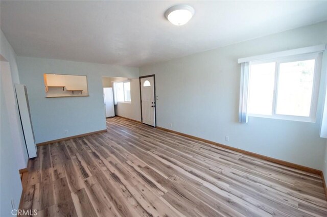 unfurnished living room featuring light wood-type flooring